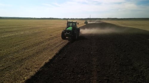 Tractors plowing the field in Ukraine