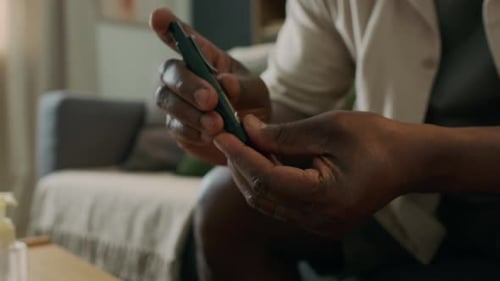 Close Up of Man Pricking Finger and Using Glucose Meter at Home