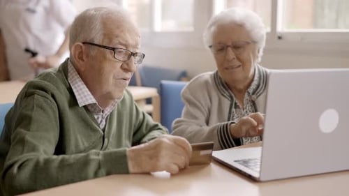 Senior People Trying to Shop Online with Laptop in Geriatric