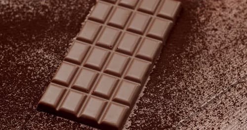 Delicious Dark Chocolate Bar On Cocoa Powder Background For Sweet Lovers
