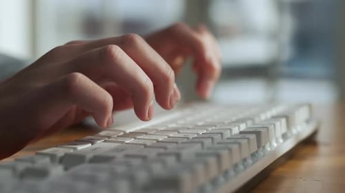 Man Working on Desktop Computer in Home Closeup