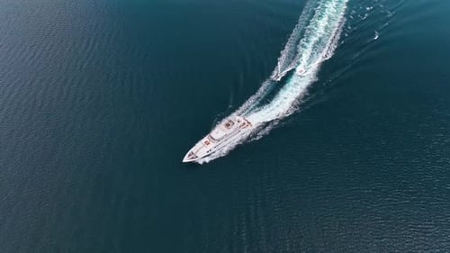 An aerial view of the yacht on the blue sea. Transparent clear water in the sea.