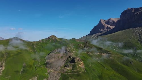 A Drone Captures the Stunning Beauty of Lush Green Mountains Under a Clear Blue Sky