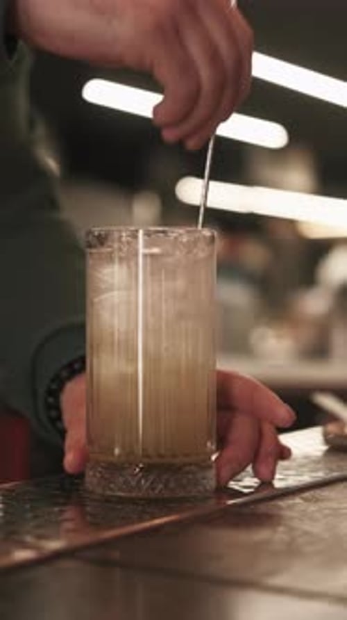 Refreshing Cocktail Being Mixed with a Bar Spoon