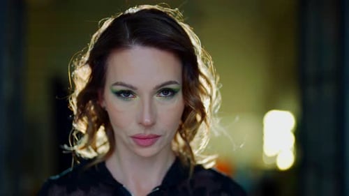 Woman with Green Eyeshadow Looking at Camera