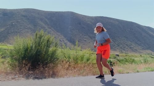 Full Figured Girl Runs a Hot Mountain Trail Pushing Through Fatigue