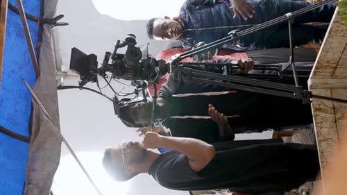 Camera Crew Filming with Equipment