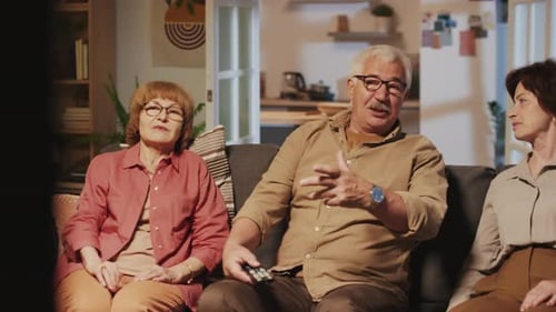 Seniors Watching Television Together on a Couch