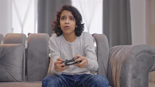 Indian kid boy playing video games