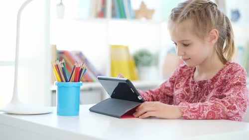 Girl with Tablet at Desk