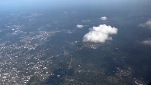 Aerial View of Sprawling Cityscape with Clouds