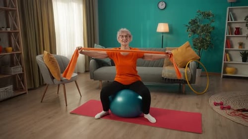 Senior Woman Exercising with Resistance Band at Home