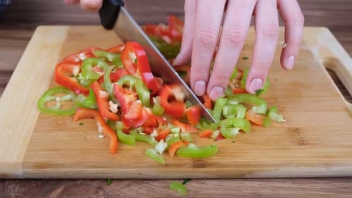 Chopping Peppers on a Cutting Board