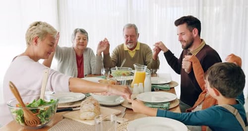 Family Holding Hands at Mealtime