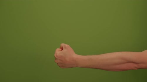 A Strong and Powerful Gesture of Determination A Fist Enveloped By a Bright Green Background