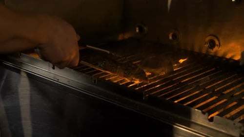 Cheff grills meat, with flames