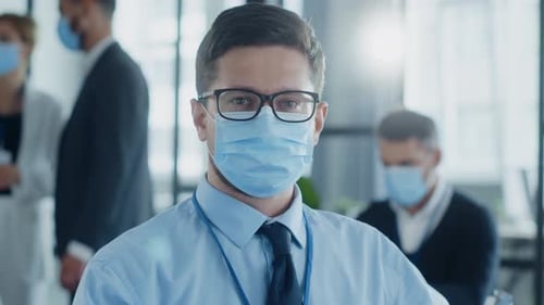 A Masked Man in an Office Symbolizes Health and Safety in Work