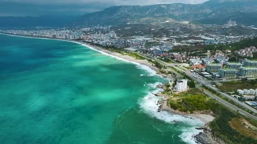 Aerial Video of Rocky Shore Surrounded By White Foam BlueGreen Water and Crashing Ocean Surf