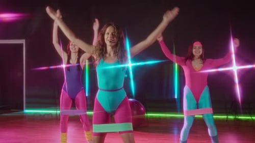 Women in Retro Outfits Exercising with Resistance Bands