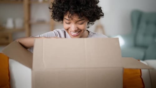 Happy Satisfied African American Woman Customer Receive Carton Box and Open Delivered Parcel Excited