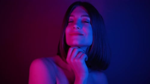 Beautiful Woman Posing Under Neon Studio Lighting