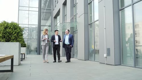 business people, colleagues, employees go along the street near the building office center. A team
