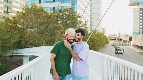 Happy gay couple walking holding hands and talking to each other on a date. They embrace in love.