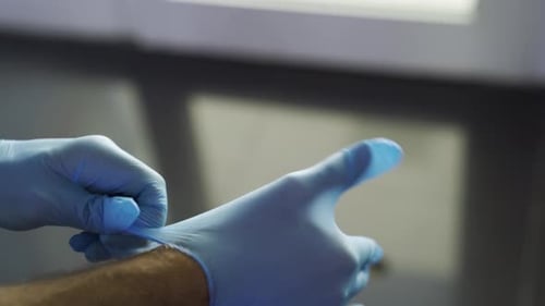 Doctor Wearing Sterile Blue Surgical Gloves