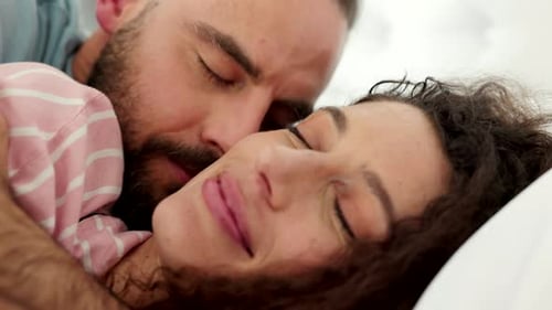 Affectionate Couple Sleeping Peacefully in Bed Together