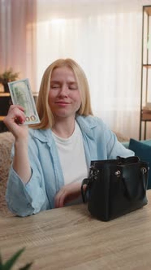 Woman Finding Extra Money Cash in Small Hand Bag at Home Surprise Amazement Unexpected Happy Bonus