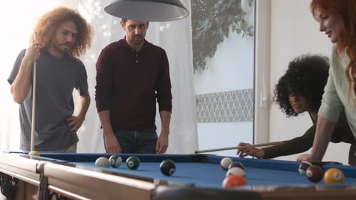 Happy Woman Pocketing Pool Ball with Successful Shot in Game Room