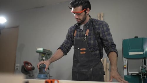 Carpenter is working at workshop.