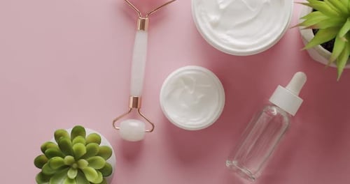 Top View of Hydrating Cream Hyaluronic Serum and Quartz Facial Roller
