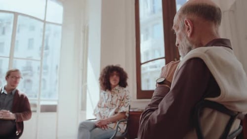Three People Seated in a Bright Indoor Room