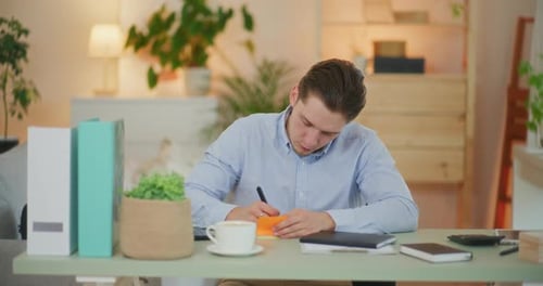 Young Adult Writing Notes at Bright Desk