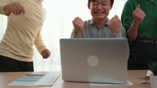 Enthusiastic Team Celebrating Success in Modern Office