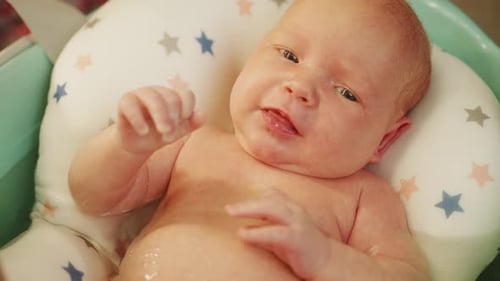 Cute Infant Relaxing in Small Tub