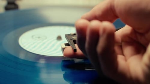 Close up of vitage record finishing and a hand retiring the needle