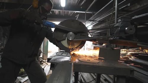 Man Use Saw Cutting Machine to Cut Metal Unrecognizable Guy with Circular Saw Sawing Steel in Garage