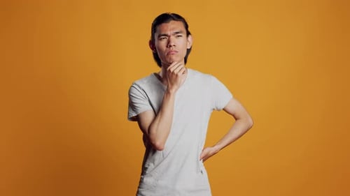 Pensive Young Adult Thinking About Solution in Studio