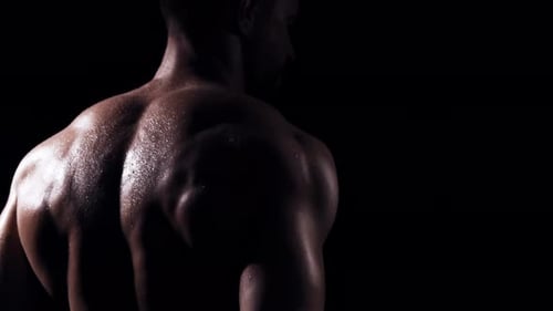Fit and Sporty Bodybuilder Over Black Background Bodybuilder Training Using Barbell The Concept of