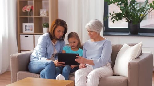 Three Generations Watching a Tablet Indoors at Home