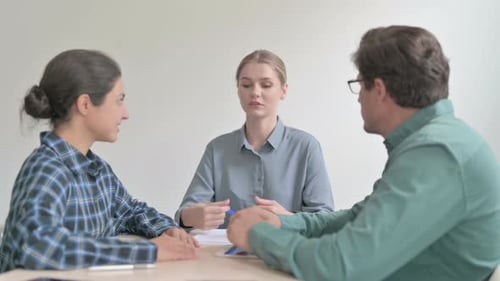 Professional Woman Leads Meeting with Team Members