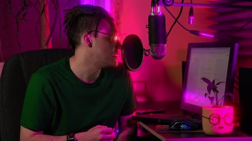 Man Recording Podcast in Neon Lit Studio