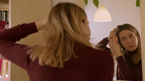 Woman Applies Makeup in the Mirror at Home