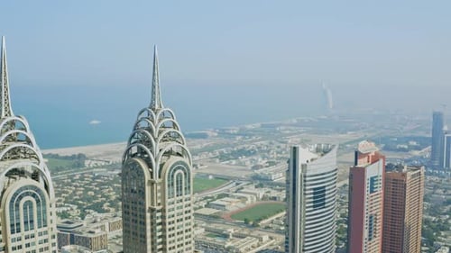Aerial drone view Close Up of the Business Central Towers in Dubai, United Arab Emirates