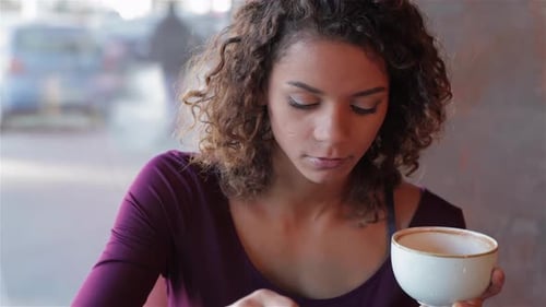 Woman Enjoying Coffee in Urban Setting