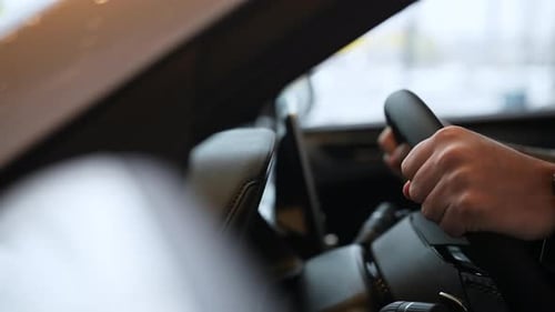 Closeup Tracking Shot of Unrecognizable Young Man Customer Choosing New Car in Dealership Center