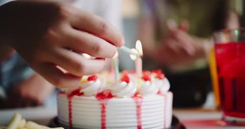 Friends Celebrate Birthday with Cake and Candles