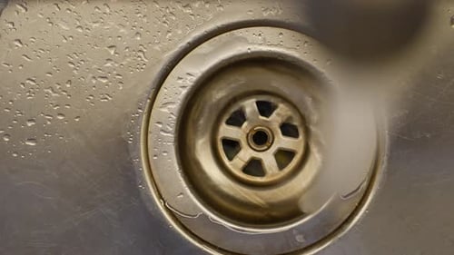 Water Flowing Down Sink Drain Close Up